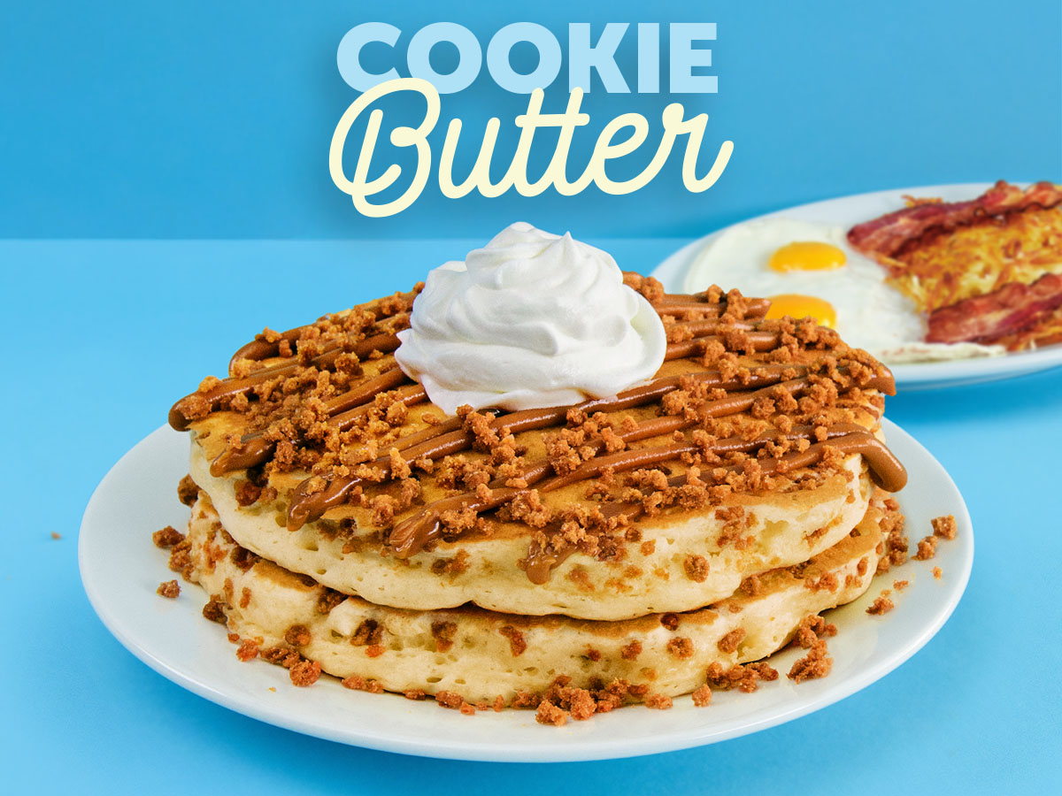 Two Cookie Butter Pancakes, filled with cookie pieces and topped with Biscoff Cookie Butter, whipped topping, and cookie crumbles