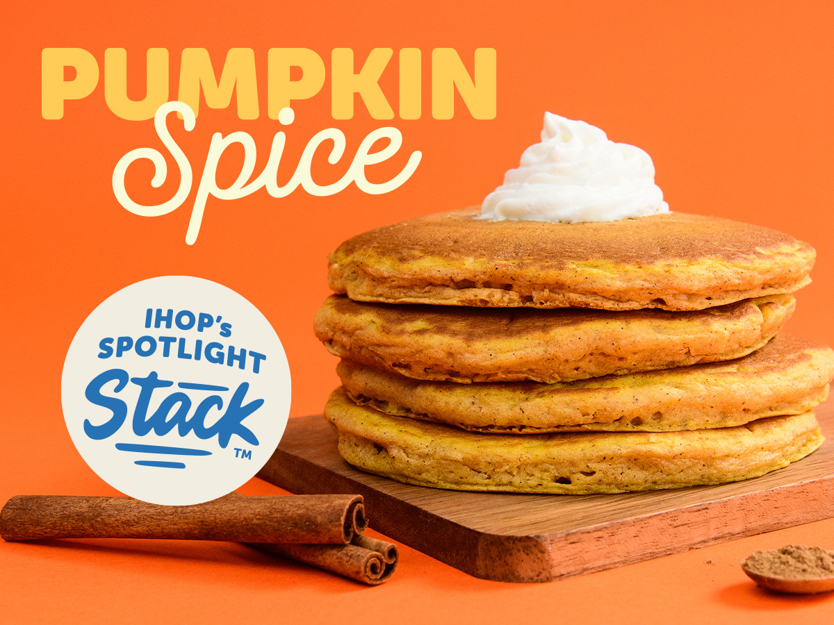 A&nbsp;stack of Pumpkin Spice Pancakes with whipped topping sit on top of a wooden cutting board. Beside them are two stick of cinnamon. There is a bubble with the text IHOP's Spotlight Stack.
