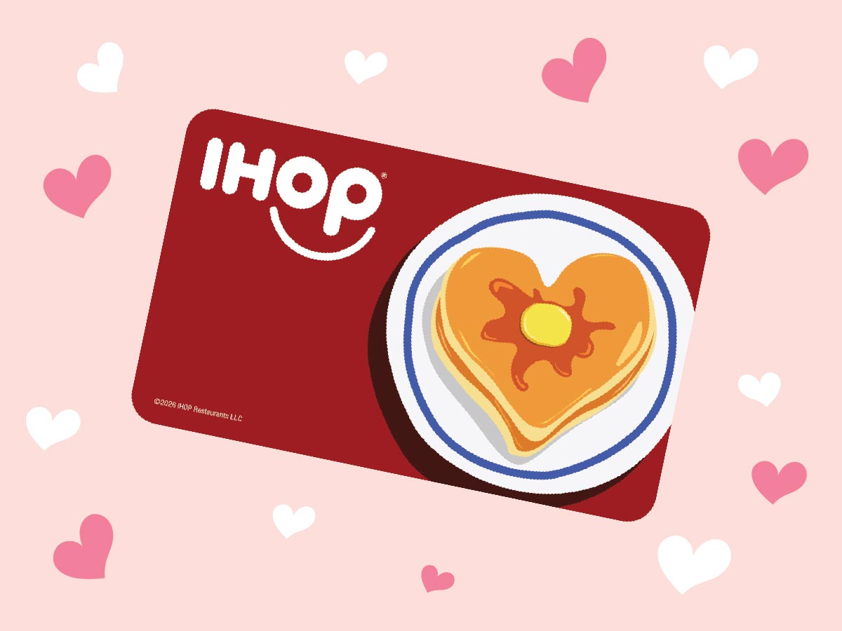 Image of an IHOP Gift Card with illustrated heart-shaped pancakes on it, set against a pink and white heart patterned background
