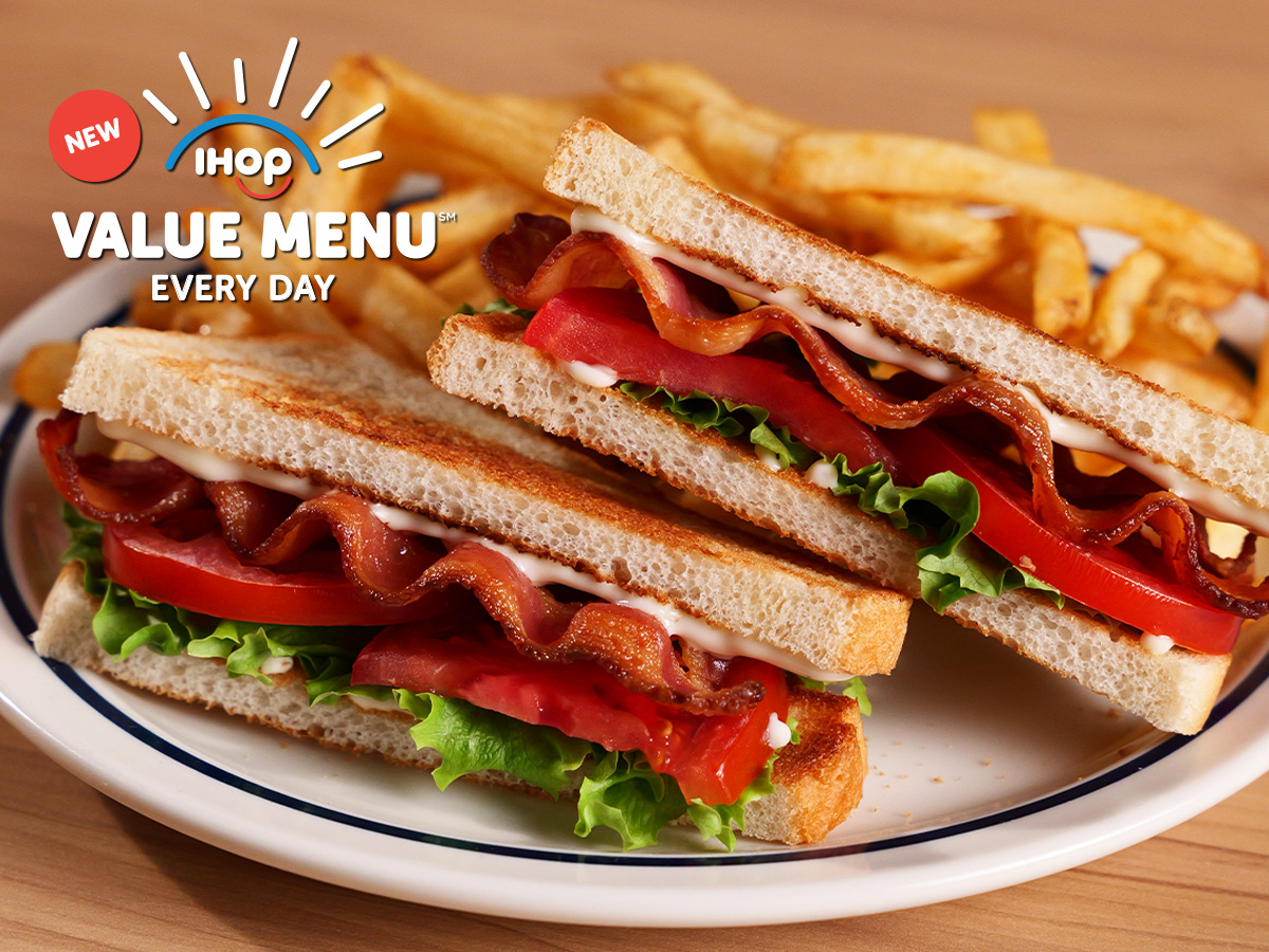 The Value Menu BLT and fries on a plate on a wooden table.
