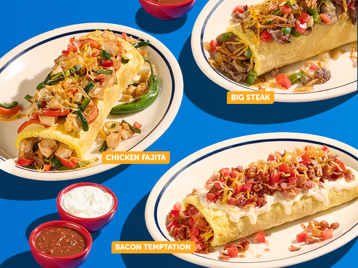 An assortment of IHOP Stuffed ‘N Stacked Omelettes on plates against a blue background, including the Big Steak and Chicken Fajita