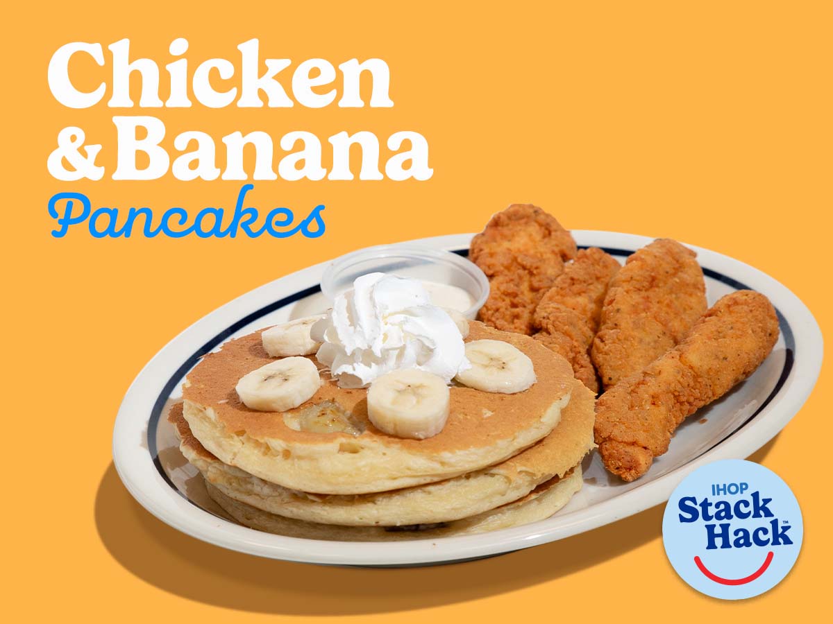 Stack of 3 pancakes with bananas on top with chicken strips on the side