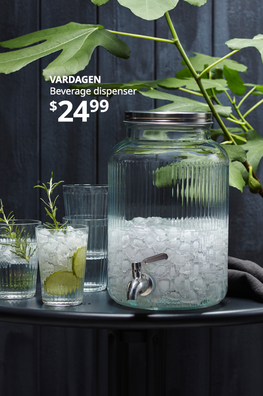 Glass beverage dispenser on table. 