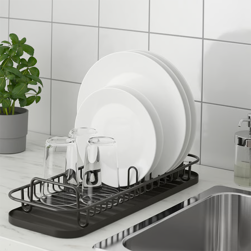 Black dish rack on sink. 