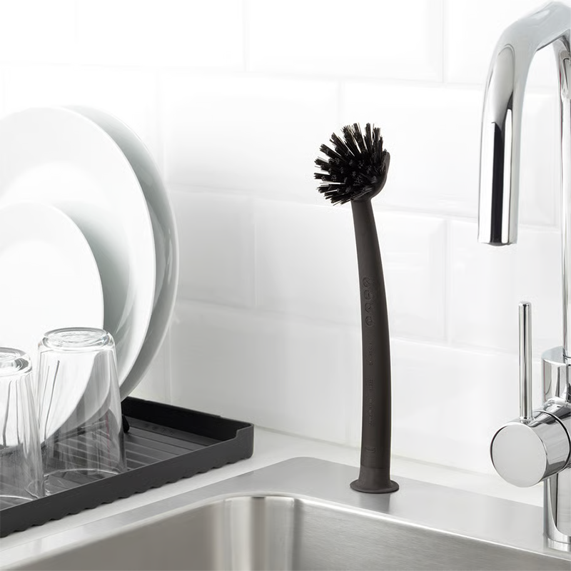Black dish brush on sink.