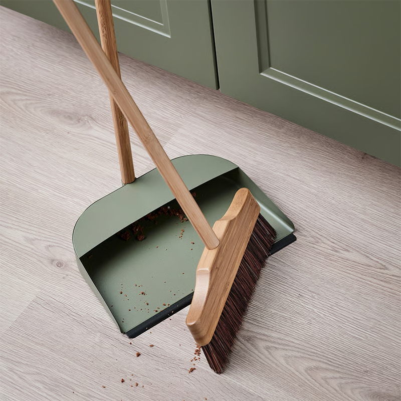 Green dustpan and broom. 
