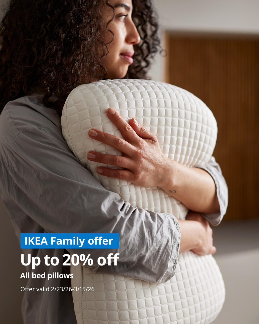 Woman hugging IKEA bed pillow