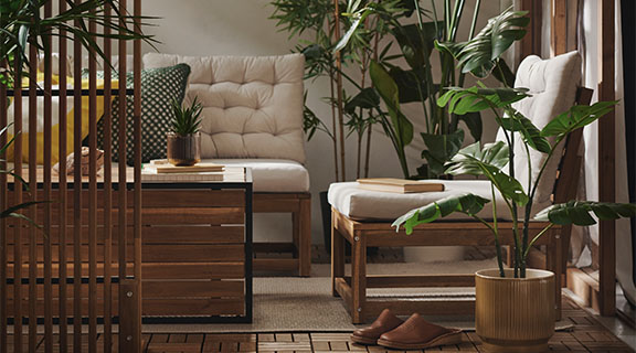 The NÄMMARÖ chair offers seating in a small, enclosed porch.