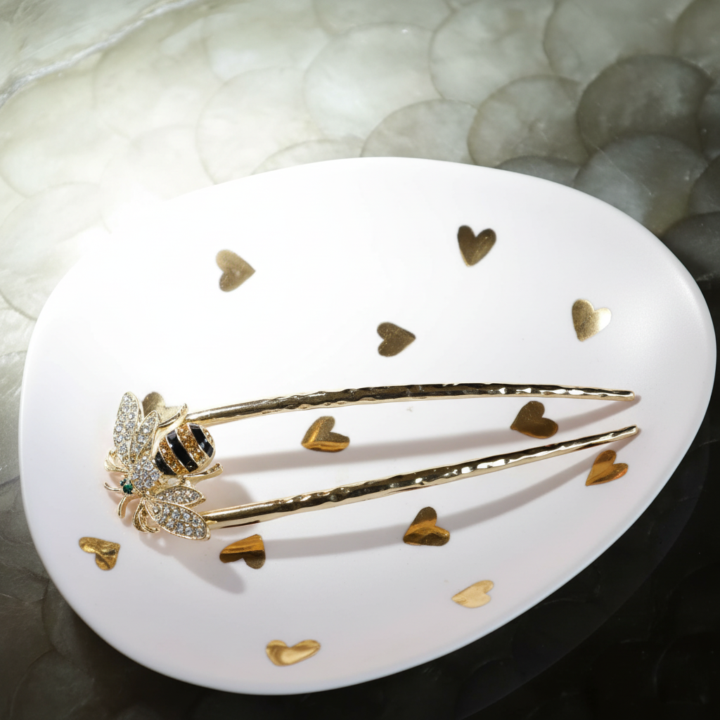 an image of a plate with a gold hair clip and a diamond owl