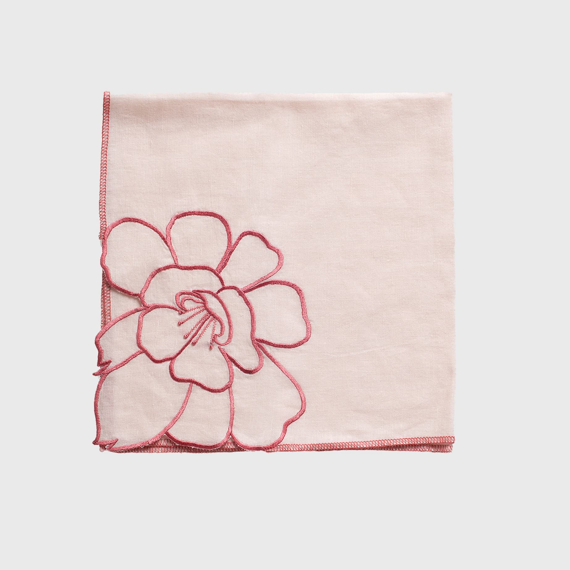 Close-up of delicate pink and white peonies with a bright yellow center.