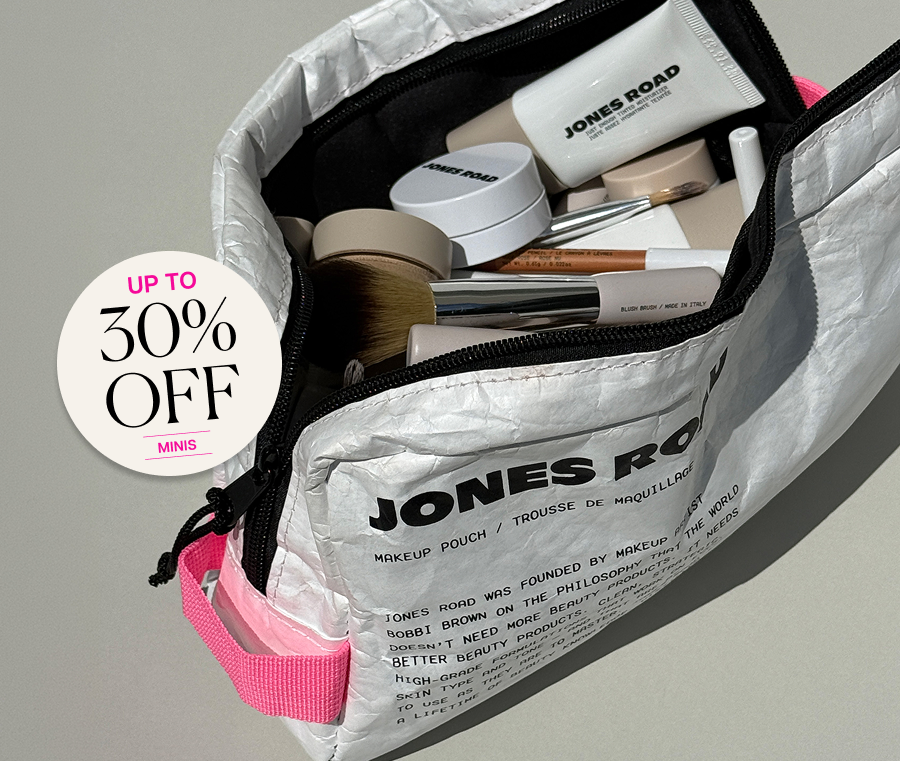 Jones Road makeup pouch filled with mini beauty products and brushes.