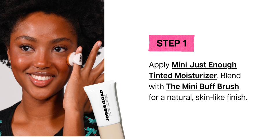 Model applying Jones Road Mini Just Enough Tinted Moisturizer with Mini Buff Brush for a natural finish.