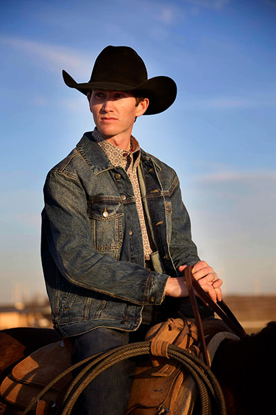 A cowboy sitting on a horse.