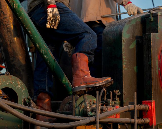 A man wearing Justin Boots while working.