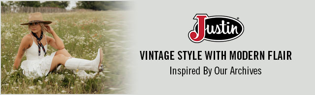 A woman sitting in the grass wearing Justin western boots. Justin Logo. Vintage Style With Modern Flair. Inspired By Our Archives