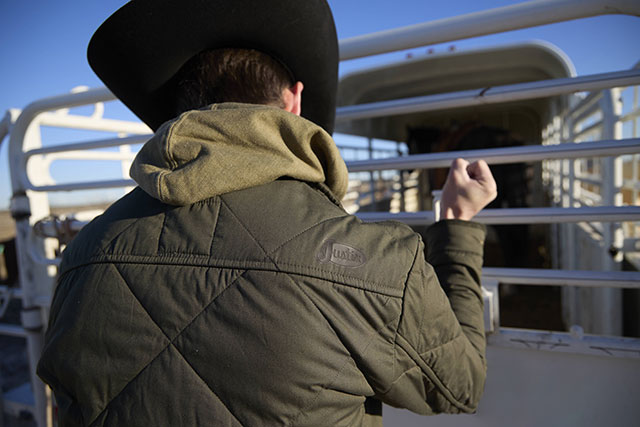 A man wearing the Justin Quilted Jacket in olive.