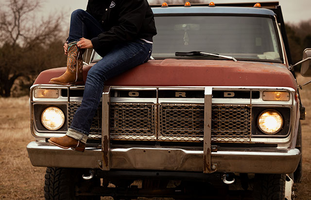 A woman wearing the Miss Ellie 11" Western Boot in taupe.