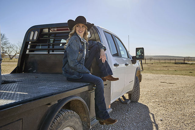 A woman wearing the Annie Up 13" Western i sedona brown.