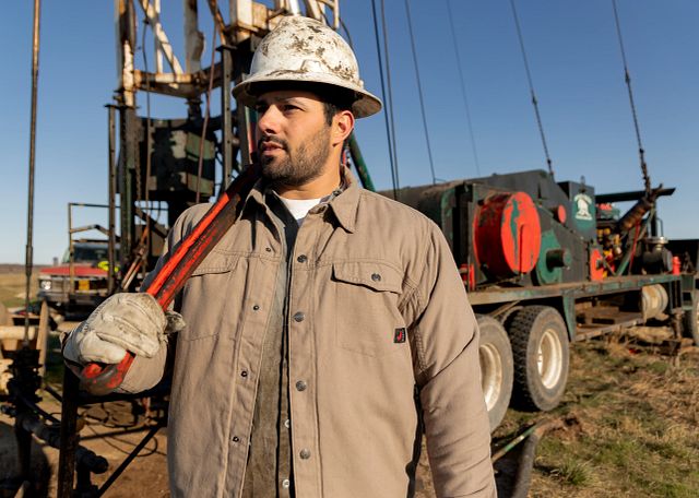 A man wearing on hard hat on a job site.