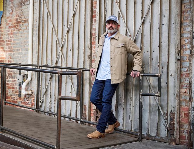 A man weaing Justin 1879 Straight Leg Mens Jeans in dark wash.