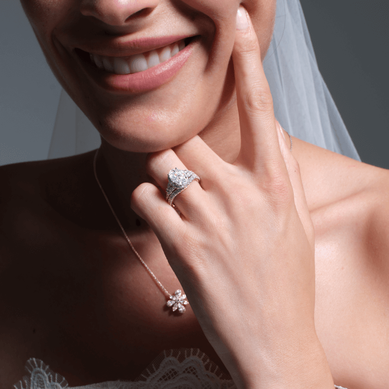 Bride showcasing necklace and rings.