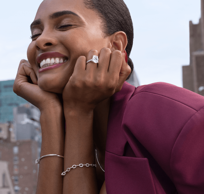 Woman showcasing bracelets and rings.