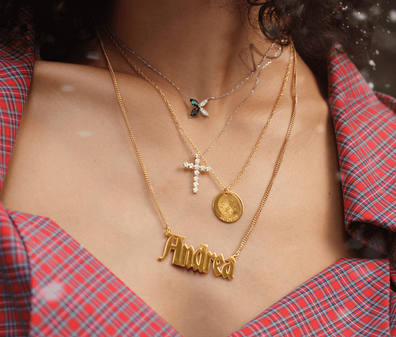 Woman showcasing necklaces.