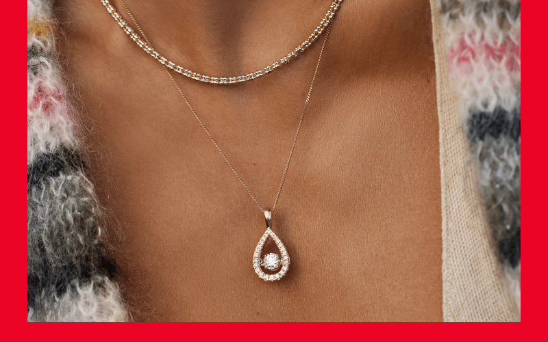 Woman showcasing necklaces.