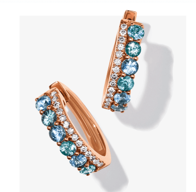 Rose-gold hoop earrings set with a row of blue gemstones.