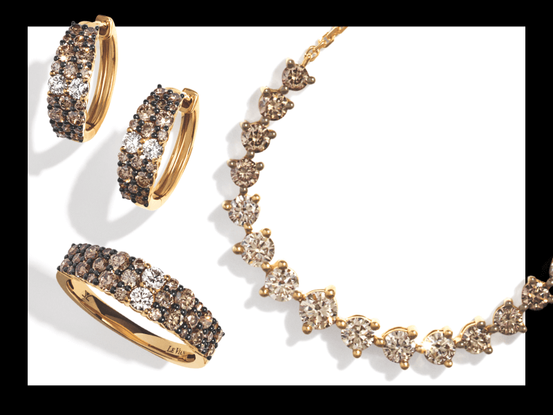 Gold jewelry set including brown-diamond hoop earrings, a matching band, and a heart-shaped diamond necklace.