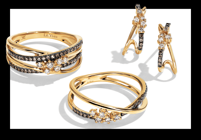 Gold crossover rings with chocolate and white diamonds shown beside matching diamond drop earrings.