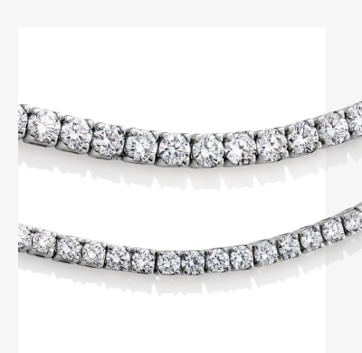 Two layered white gold and diamond tennis bracelets.
