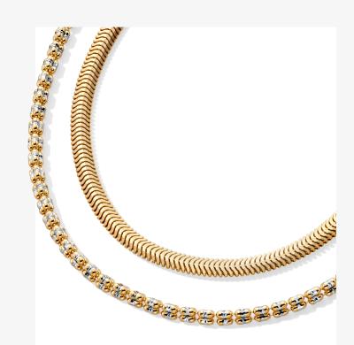 Layered gold chain and gold tennis necklace.