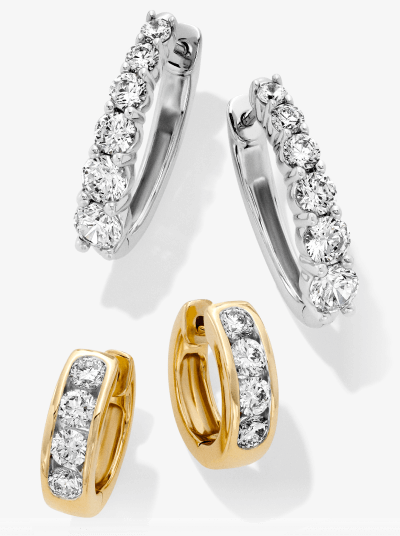 White and yellow gold diamond hoop earrings with round diamonds side by side.