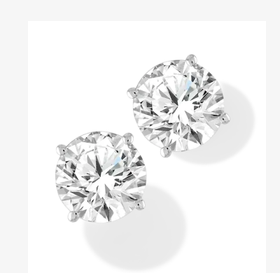 Pair of white gold diamond stud earrings featuring clustered round diamonds arranged in a floral design.