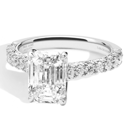 White gold engagement ring with an emerald-cut diamond and diamond-accented band.