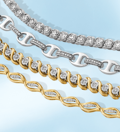 Layered yellow and white gold bracelets with diamond accents.
