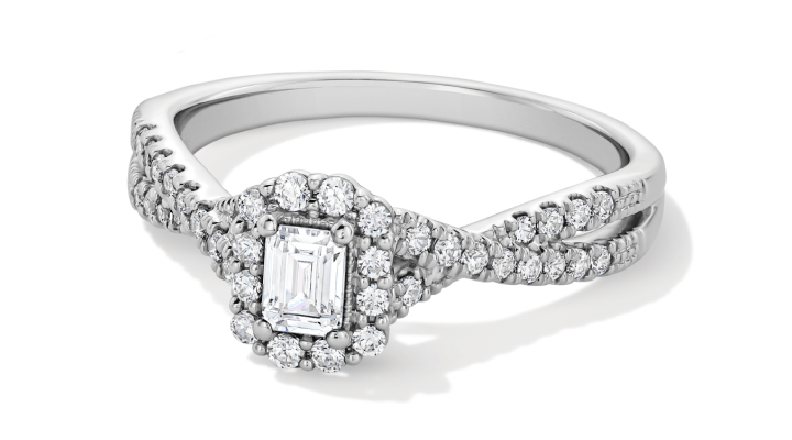 White gold twisted halo emerald cut engagement ring.