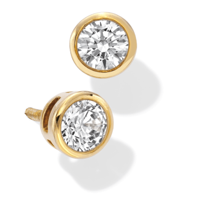 A pair of yellow gold bezel-set diamond solitaire stud earrings. 