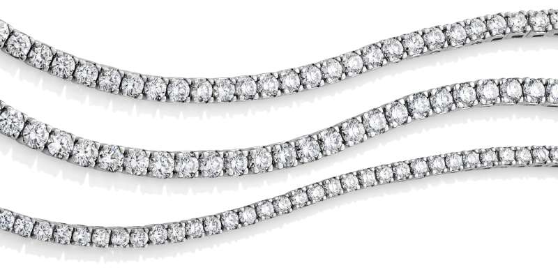 Three diamond tennis bracelet strands with different stone sizes. 