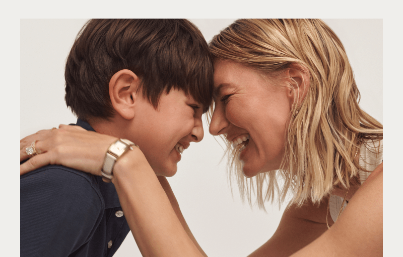 Mom and Son Smiling and Touching Foreheads in a Joyful Moment. Mom is Wearing a Watch and diamond ring.
