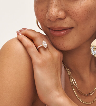 Image of woman wearing similar engagement ring and variety of fine jewelry.
