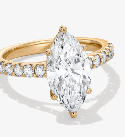 Yellow gold pave band marquise cut engagement ring.