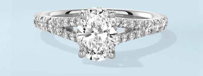 White gold oval cut engagement ring with pave twist band.