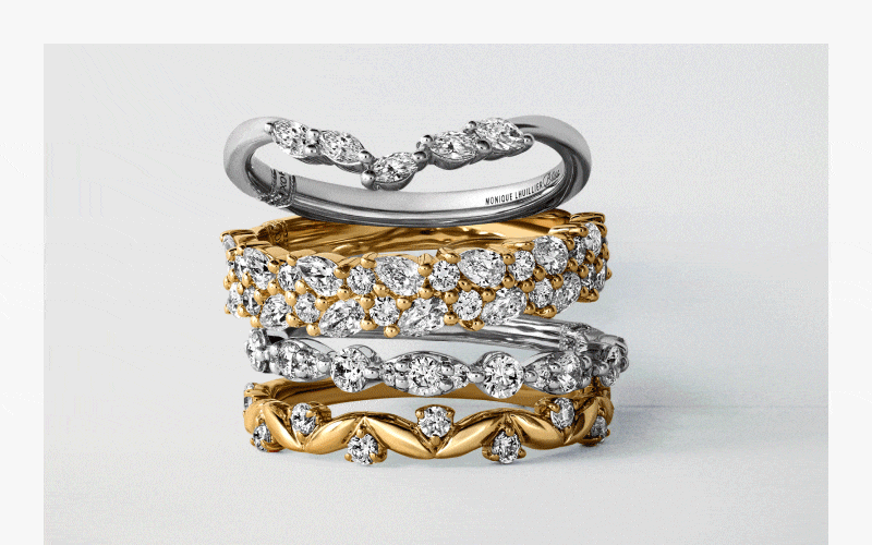 A stack of diamond wedding bands, several silver chains, blue gemstone set, Bulova watch. 