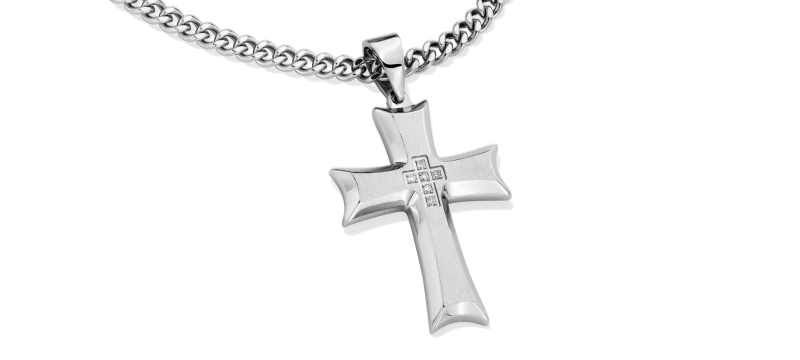 Cross pendant with diamond details in the center on a silver chain.