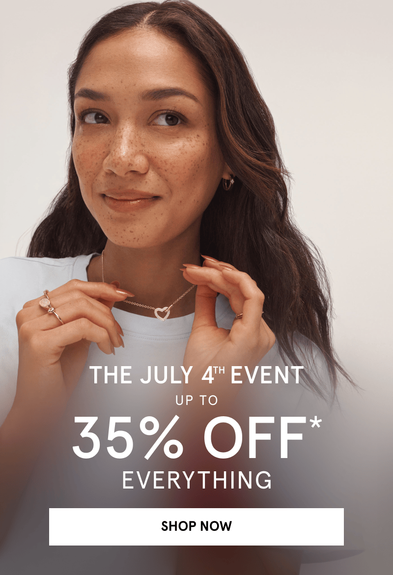 Woman wearing a heart shaped necklace in gold and gold rings. The July 4th event. Up to 35% off everything. Click Shop Now. 