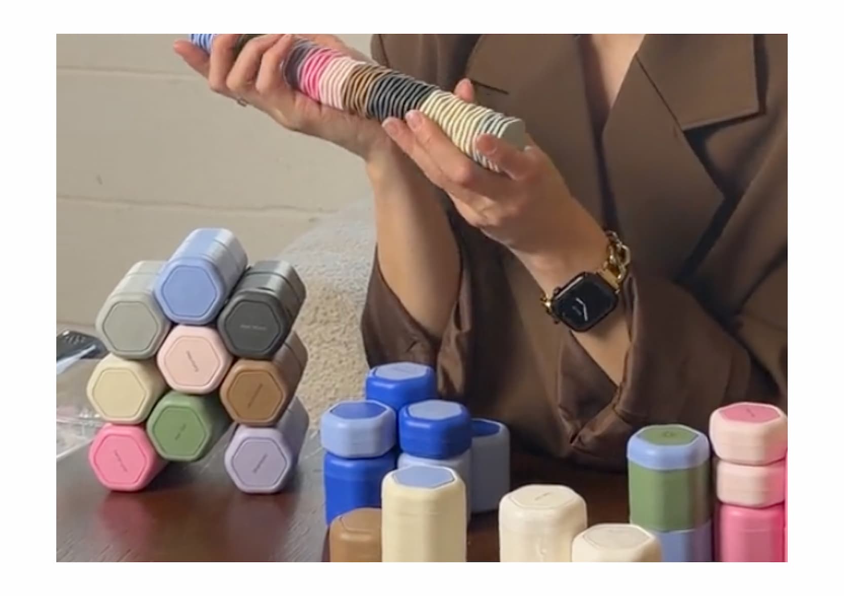Click to shop The Capsules. Image of Steph holding up different Tile colorways.