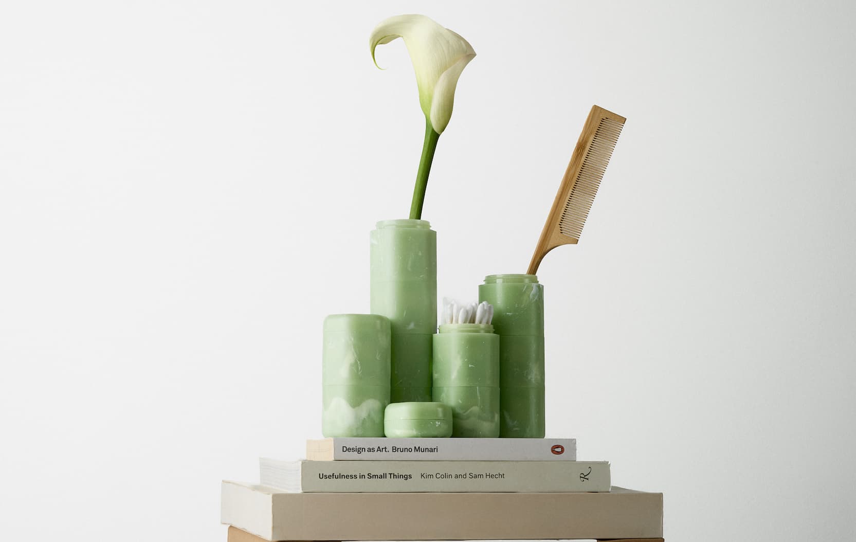 Click to shop The Jade Collection. Image of Jade Capsules filled on top of books.