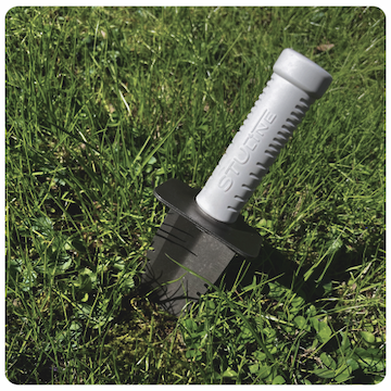 Stu-Line hand digger dug into the grassy ground
